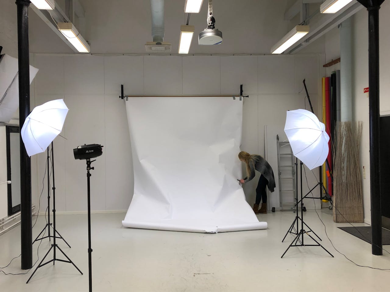 A professional photography studio setup with softbox lighting and white backdrop.